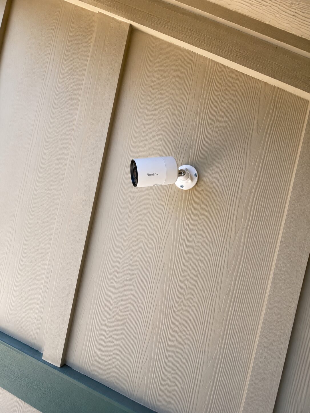 Reolink bullet camera installed on exterior siding