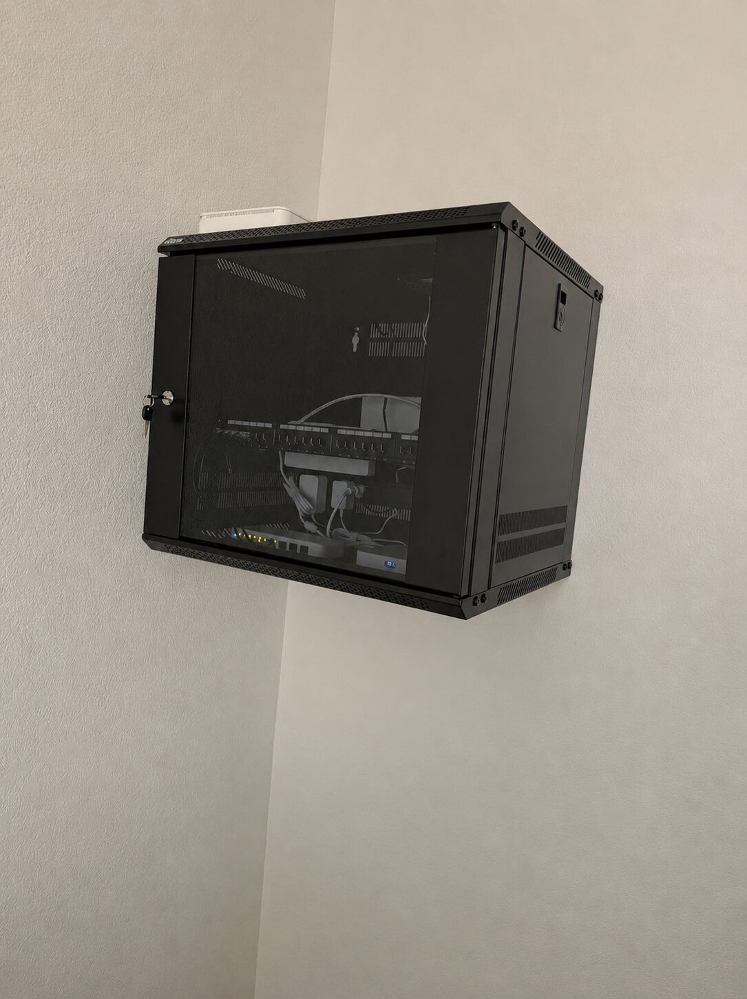 Wall-mounted network cabinet, fully wired and organized