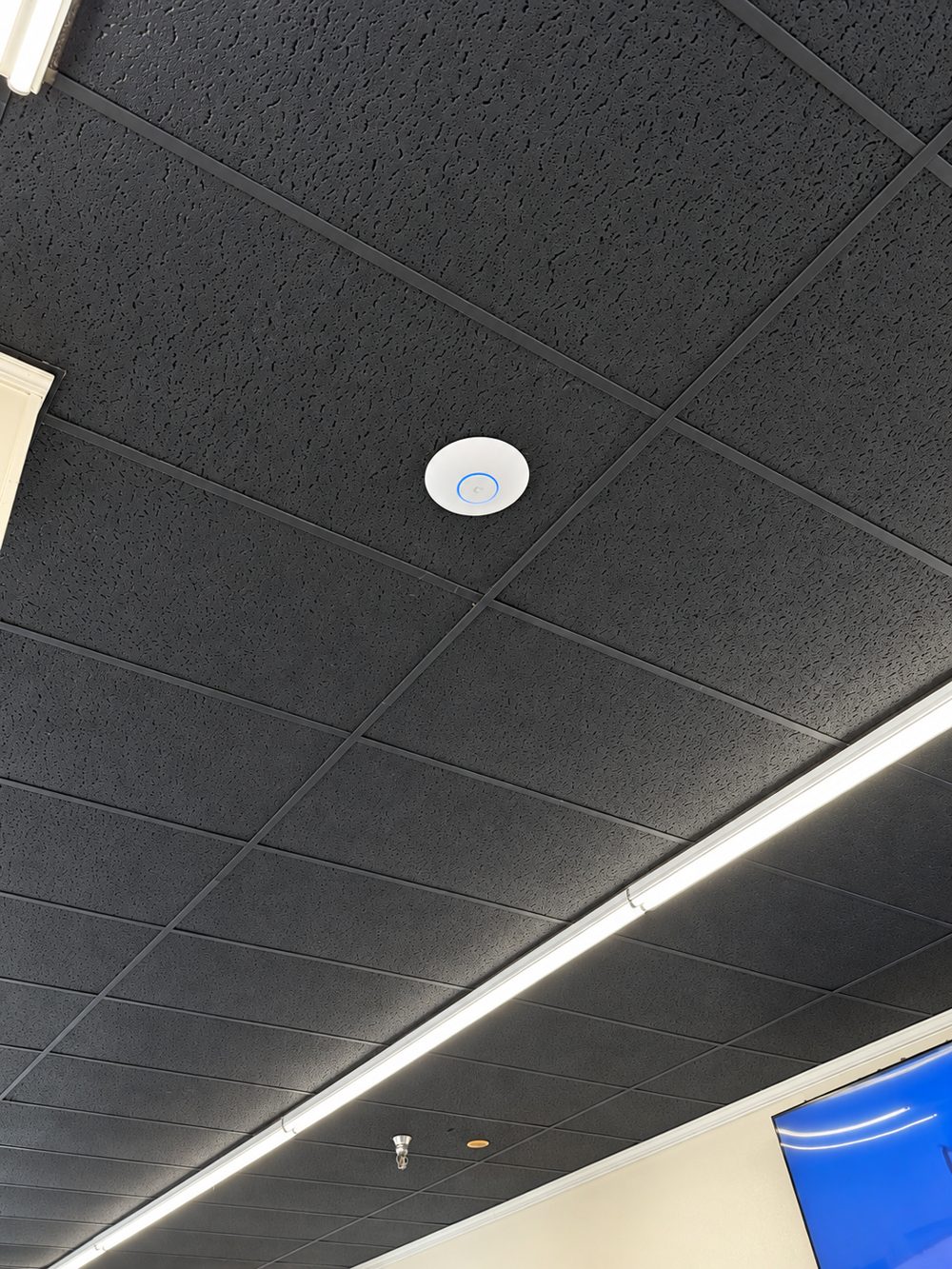 UniFi access point in a commercial drop ceiling